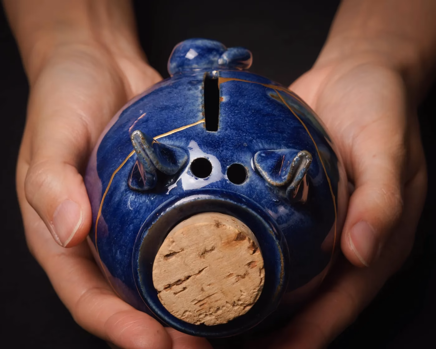 Ceramic piggy bank repaired with gold kintsugi